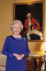 Queen Elizabeth II stands in the 18th Century Room at London's Buckingham Palace