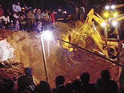Rescue work under progress at Bains village where a labourer was buried alive on Thursday night.