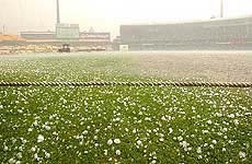 The pitch of the Sydney Cricket Ground shortly after rain and hail stopped play
