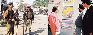 Central forces stand guard at Kila Raipur and (right) residents read posters reminding them of the anti-Sikh riots in 1984.