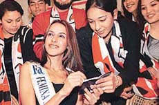 Miss India Universe 2002 Neha Dhupia signs autograph books