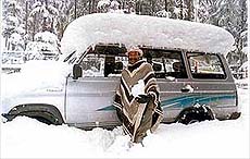A car stands covered with snow