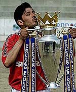 Afghan player Syed Daud kisses the English Premiership League trophy