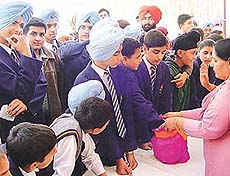 Students of YPS Mohali take out a lucky draw at the fete held on the school campus on Saturday.