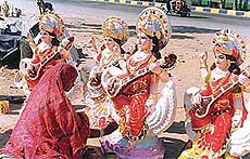 Idols of Goddess Saraswati being given finishing touches by Shanti Devi in Ludhiana.