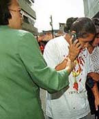 An injured woman talks on a phone