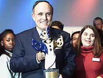 Former New York Mayor Rudolph Giuliani poses with American children