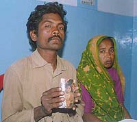The parents of Rajni show the girl’s photograph to mediapersons at Bathinda on Monday.