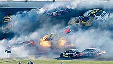 Race cars tangle around the number (18) car of Kenny Wallace is engulfed in flame in turn two during running of the 44th annual Daytona 500 at the Daytona International Speedway on Sunday.