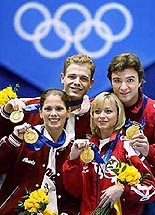 Elena Berezhnaya, second from right, and Anton Sikharulidze, right, of Russia and Jamie Sale, left, and David Pelletier of Canada pose with their gold medals at a special awards ceremony for the figure skating pairs competition at the Winter Olympics in Salt Lake City, on Sunday.