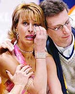Italian figure skater Barbara Fusar Poli (L) is consoled by coach Roberto Pelizzola after her partner Maurizio Margaglio fell during their free dance performance at the Salt Lake 2002 Olympic Winter Games.