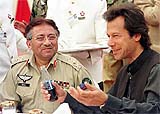 Pakistan President General Pervez Musharraf (L) and former cricketer-turned politician Imran Khan talk at a charity fundraising function