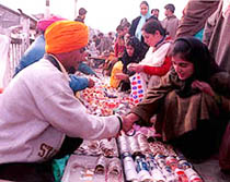 Young Kashmiri girls try to get choicest colourful bangles