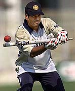 India�s star batsman Sachin Tendulkar uses a wicket to give catching practice 