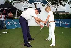 Former Spice Girl Geri Halliwell is given a short golf lesson by compatriot Nick Faldo