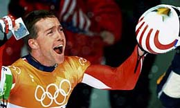 Jim Shea of the USA holds a picture of his deceased grandfather after winning the gold medal