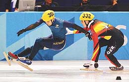 Australia's Steven Bradbury (L) slips and falls in front of Germany's Andre Hartwig during a 1500 m short track heat