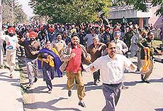 Cheerful supporters of the Congress candidate, Mr Bir Devinder Singh, rush towards the counting centre to garland him at Shivalik Public School, Phase VI, SAS Nagar, on Sunday.