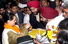Congress President Sonia Gandhi being offered a sweet