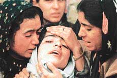 Neighbours console the daughter of National Conference block president Abdul Bashir Dar