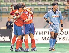 Jugraj Singh (R) looks dejected while Korean players celebrate after scoring their second goal