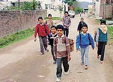Children at Kansal village, return to their homes after taking tuitions. Students from the village are not allowed to attend schools as a precaution against the plague.