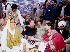 Some Congress leaders squat on the ground along with Mrs Ambika Soni, Mrs Rajinder Kaur Bhattal and Mrs Parneet Kaur, wife of Punjab CM (extreme right), during the oath ceremony at Punjab Raj Bhavan in Chandigarh on Wednesday.