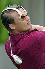 Jarmo Sandelin of Sweden follows through while wearing his designer sun glasses, on Wednesday during the Carlsberg Malaysian Open Skins Shootout at the Royal Selangor Golf Club in Kuala Lumpur. 