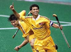 Mirnawan Nawawi of Malaysia (R) celebrates after scoring his team's third goal while followed by team-mate Chua Boon Huat 