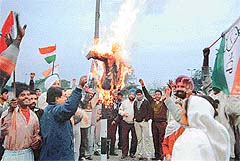 Workers of the Nationalist Congress Party burn an effigy of the Union Budget 