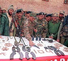Security forces display arms and ammunition seized from three Hizb-ul-Mujahideen militants