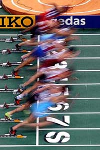 Participants of the 60 mt event set off from the blocks during a first round heat at the European Indoor Athletics Championships 