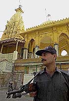 A policeman stands guard outside a Hindu temple in Karachi