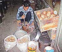 Herbal medicines beingpounded by workers and sold in sacks.
