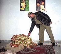A policeman examining the shootout site.
