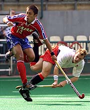 Japan's Akihiko Hirata jumps as he tries to stop England's Mark Pearn