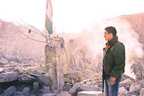 A Palestinian policeman looks at the rubble of Yasser Arafat's Force 17 headquarters 