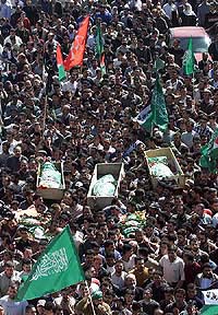Mourners carry the bodies of three out of six Palestinians