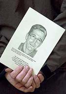 A portrait of the Wall Street Journal's reporter Daniel Pearl is held at a memorial service