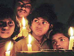 FLICKERING HOPE: The waves of terror that drowned Gujarat seem to have frozen in the tender eyes of these children who took part in a candle-light march held at Sector 17, Chandigarh, on Wednesday.