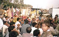 Slum dwellers, who were relocated at Bhalsawa, holding a meeting to discuss the lack of civic amenities at the camp.
