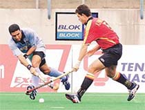 Deepak Thakur (L) hits the ball