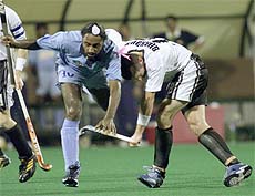 India's Baljit Singh Dhillon clashes with New Zealand's Phillip Burrows