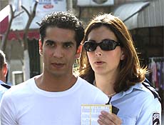 An Israeli policewoman comforts Shlomi Harel