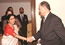Pakistani Information Minister Nisar A. Memon shakes hand with his Indian counterpart Sushma Swaraj