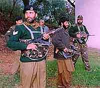 Shakeel Pathan (centre) a group Commander of Hizbul Mujahdeen Militants Organisation Surrendering his Arms before Indian Border Guards BSF in Jammu On Saturday .