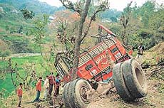 The mangled remains of a private bus carrying a marriage party