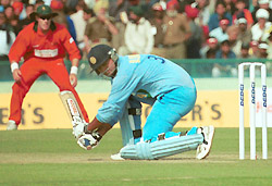 Dinesh Mongia sweeps a ball off medium pacer Heath Streak.