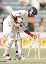 Man-of-the-match Kumar Sangakkara collects the stumps after Sri Lanka defeated Pakistan.