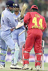 Indian batsman Mohammad Kaif (L) looks at his uprooted stumps after being clean bowled as Zimbabwe's wicket Tatenda Taibu fixes the wicket during the second one-day game in Mohali on Sunday.